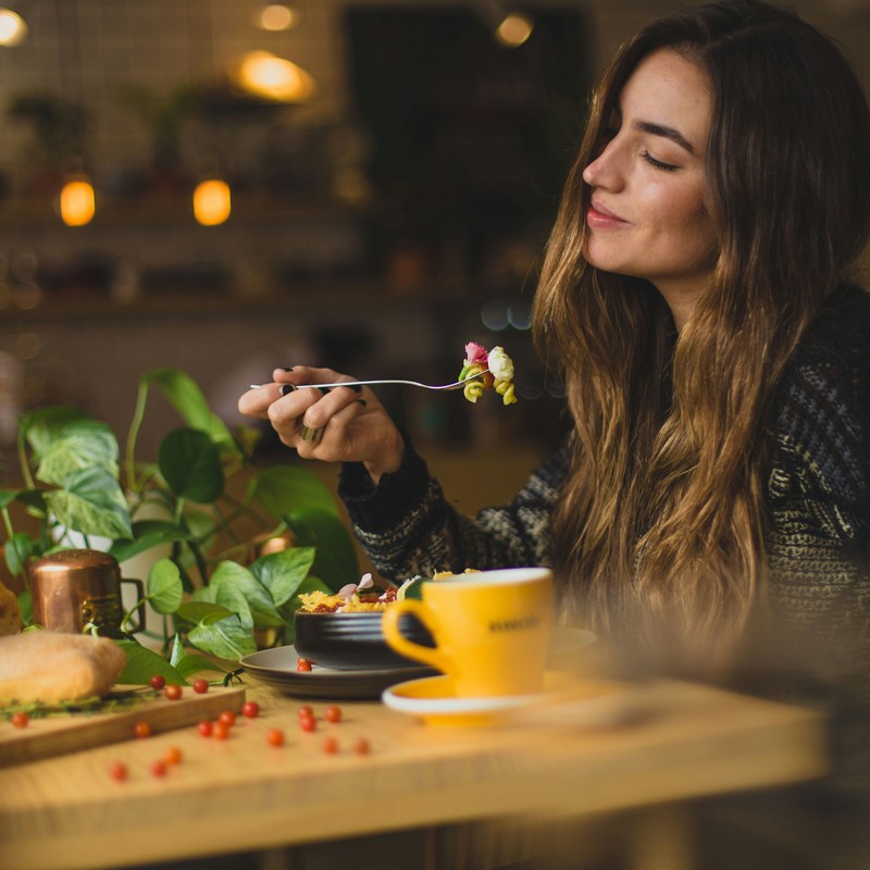 Woman savoring a bite of food.