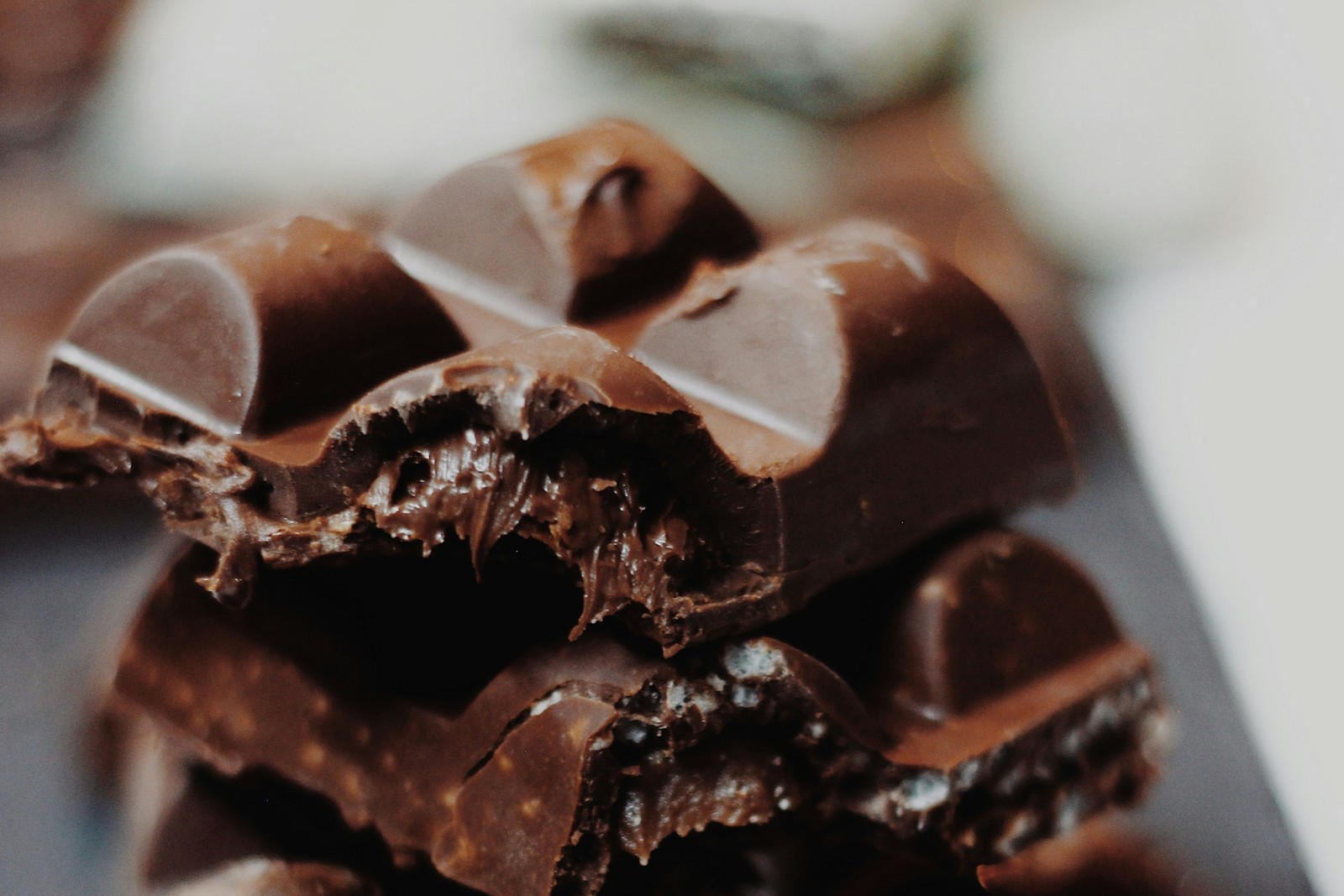 Stack of broken dark chocolate squares with gooey center.