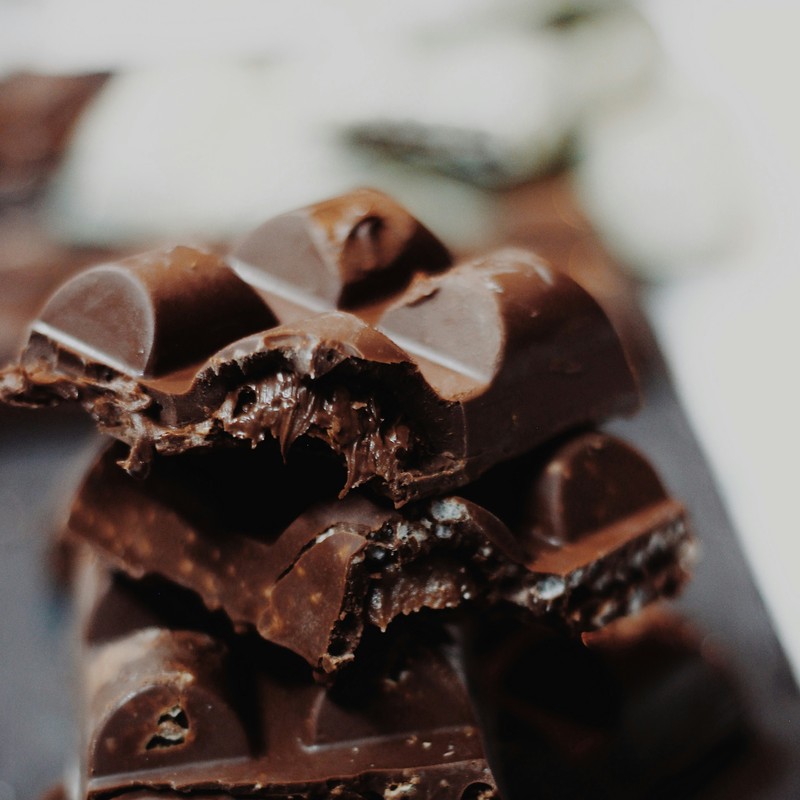 Stack of broken dark chocolate squares with gooey center.